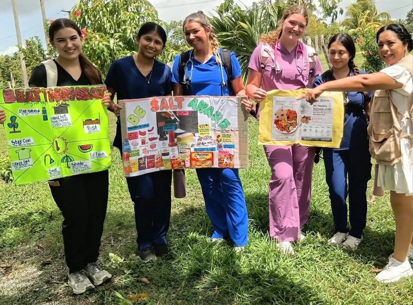 Students with community health posters in Belize